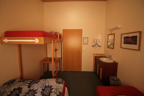 One Hvoll Hostel's rooms is basked in a golden light.