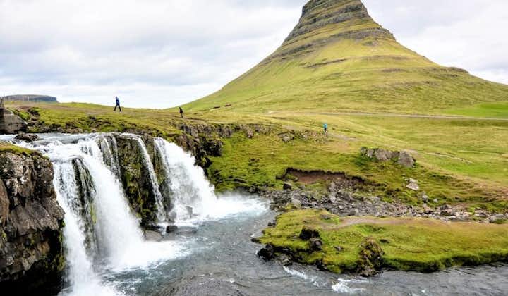 A small waterfall rushes before Mount Kirkjufell.