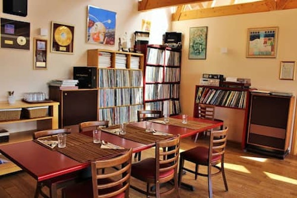 The dining area at the Fossatun Country Hotel restaurant with vinyl records stacked full on the shelves.