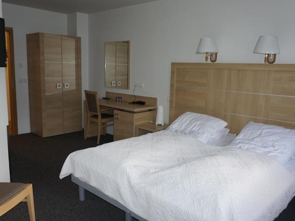 Hotel Borgarnes double room with queen bed and desk with chair.