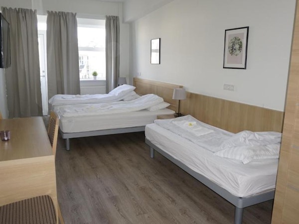 Hotel Borgarnes triple room with three single beds.