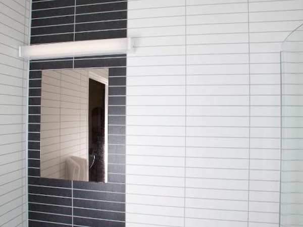 Hotel Borgarnes bathroom tile and sink with mirror.