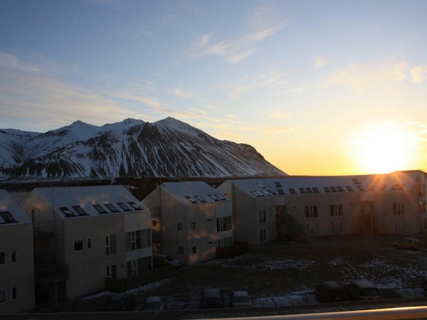 Hotel Borgarnes view of hotel and Hafnarfjall mountains at sunset.