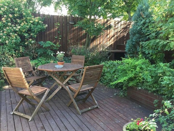 The garden is fitted with stylish wooden furniture.