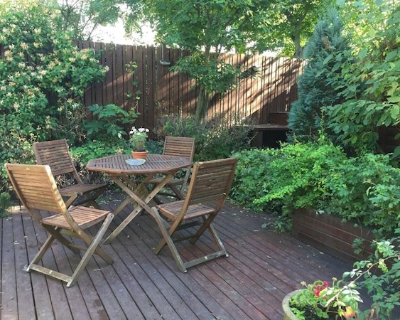 The garden is fitted with stylish wooden furniture.