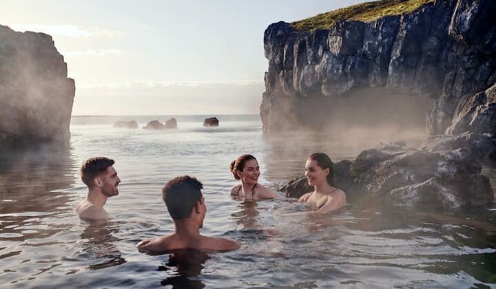 A group of friends relaxing in the thermal waters of Iceland's Sky Lagoon.