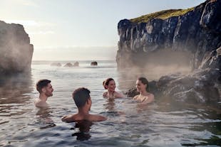 A group of friends relaxing in the thermal waters of Iceland's Sky Lagoon.
