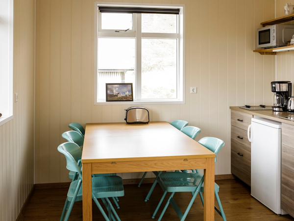 Rooms at Vik HI Hostel have tables that visitors can use for various activities.