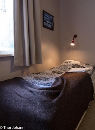 Comfortable beds await travelers at Hotel Hjardarbol.