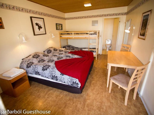 Hotel Hjardarbol's room is complete with bunk beds, a large bed for two, and a table.