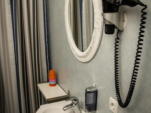 Hotel Hjardarbol's quadruple room with bathroom provides a hairdryer.