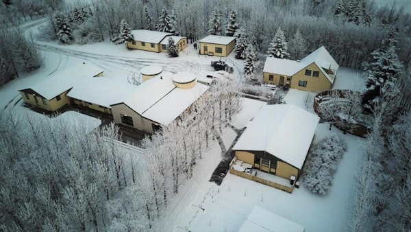During winter, Hotel Hjardarbol's surroundings are covered in snow.