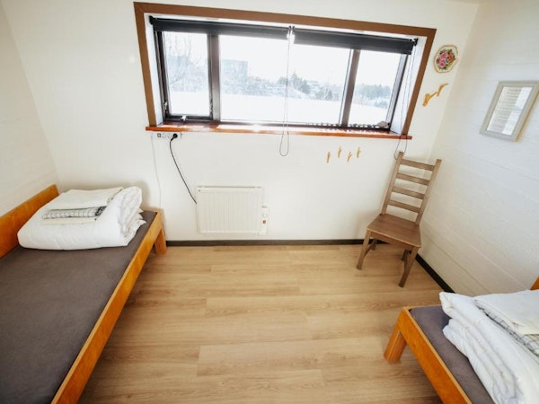 Travelers can wake up to a beautiful view at Vik HI Hostel's standard twin room with shared bathroom.