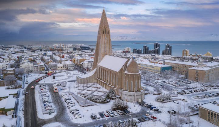 Birdseye view of Reykjavik's snow-covered landscape in winter, with Hallgrimskirkja church at the center