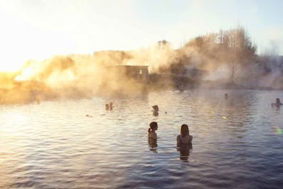 People relaxing in the Secret Lagoon hot springs.