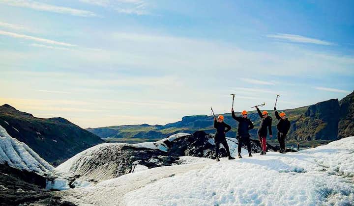 A group of friends posing after conquering the beautiful Solheimajokull glacier