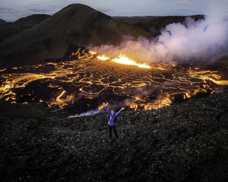 An amazing drone shot of a traveler with Fagradalsfjall volcano