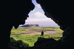 Inside the Loftsalahellir cave, overlooking Dyrholaey and the black sand beach.