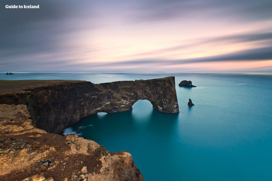 The stunning cliff and arch of Dyrholaey peninsula.