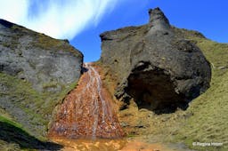 The red basalt column of Raudarfoss waterfall.