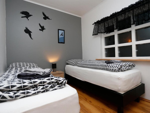 Hellnafell Guesthouse's room with single beds are decorated with birds.