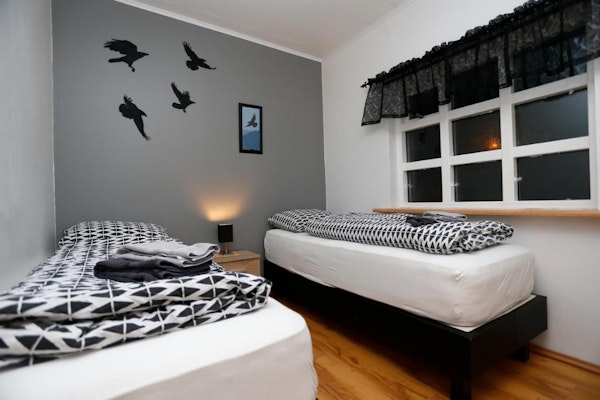 Hellnafell Guesthouse's room with single beds are decorated with birds.