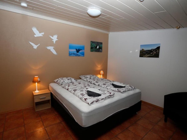 A single large double bed at Hellnafell Guesthouse, perfect for couples on a trip.