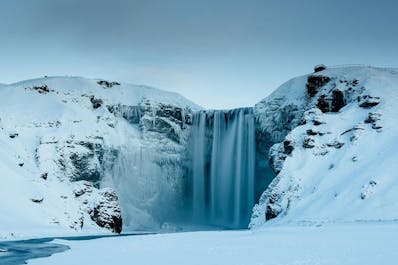 The beautiful Skogafoss waterfall partially freezes during winter.