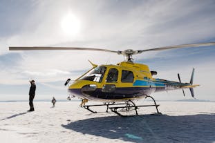 A helicopter after landing on glacier.