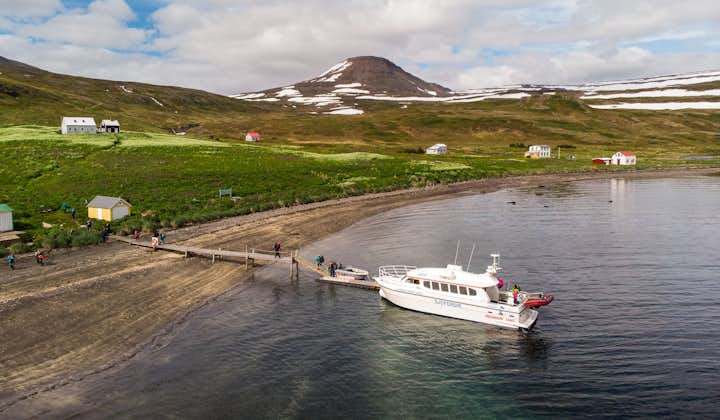 A boat docks at the abandoned village of Hesteyri in the Westfjords of Iceland.