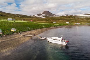 A boat docks at the abandoned village of Hesteyri in the Westfjords of Iceland.