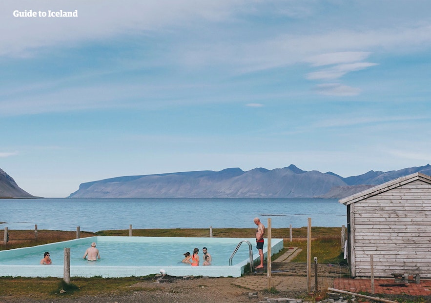 A group enjoys a soak in the pool at Reykjafjardarlaug hot spring.