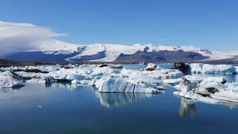 The majestic Jokulsarlon glacier lagoon with chunks of ice floating in the water.