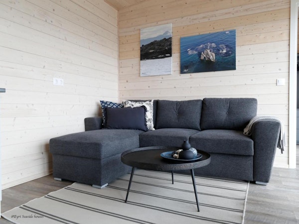 Close-up of a comfortable l-shaped sofa at Eyri Seaside Houses in Northwest Iceland.