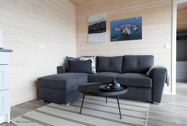 Close-up of a comfortable l-shaped sofa at Eyri Seaside Houses in Northwest Iceland.