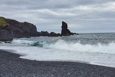 See the famous black sands of Reynisfjara beach on the South Coast of Iceland.