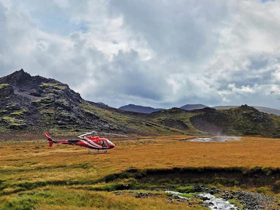 A helicopter makes a landing at Hengill geothermal area.