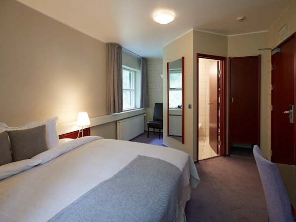 The double room at Hotel Akureyri Skjaldborg is complete with a bed and its own private bathroom.