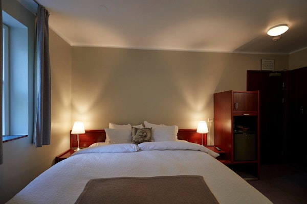 Hotel Akureyri Skjaldborg's double room is cozy and has a large double bed.