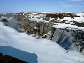 The Dettifoss waterfall is surrounded by ice and snow during winter.