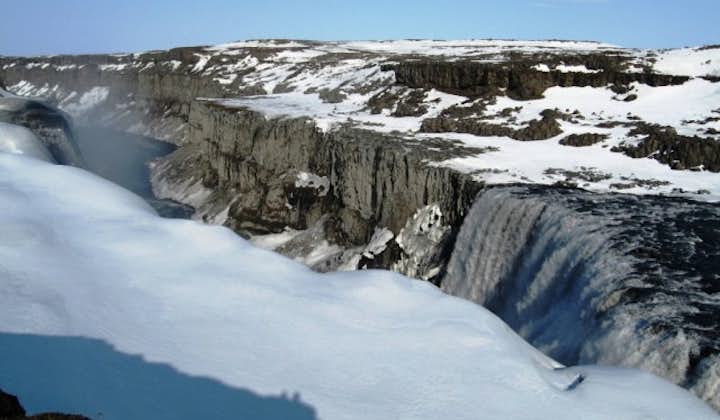 The Dettifoss waterfall is surrounded by ice and snow during winter.