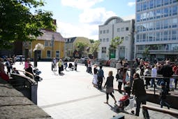 Locals and tourists strolling in Ingolfstorg square in Reykjavik.