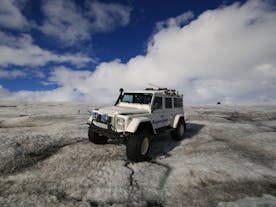 A Super Jeep parked on Iceland's rugged terrain.