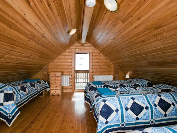 Brimnes Cabins' family cottage has five single beds available on a room upstairs.