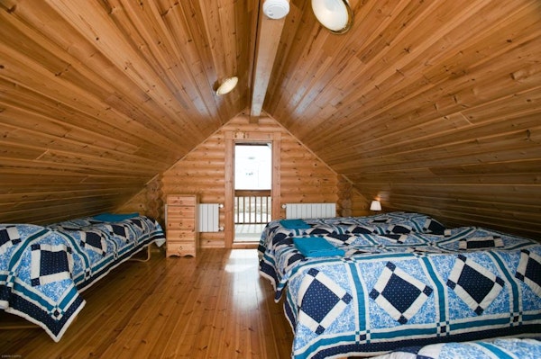 Brimnes Cabins' family cottage has five single beds available on a room upstairs.
