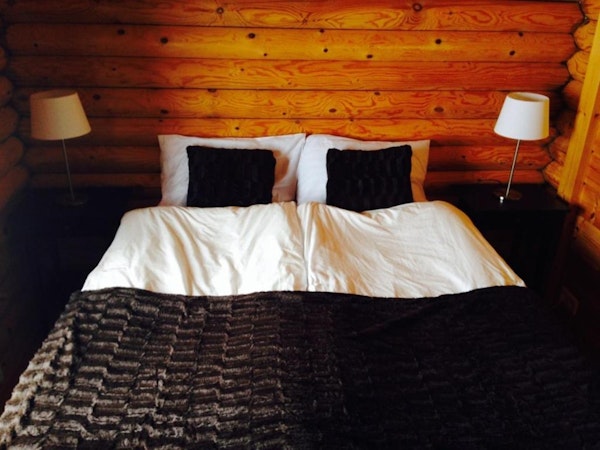 Brimnes Cabins' large cottage has a bedroom with a large double bed.