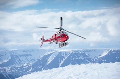 Nordurflug’s Astar B2 helicopter takes off from the peaks in North Iceland.