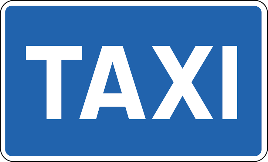 Blue rectangular sign with a white border and white writing saying "Taxi".