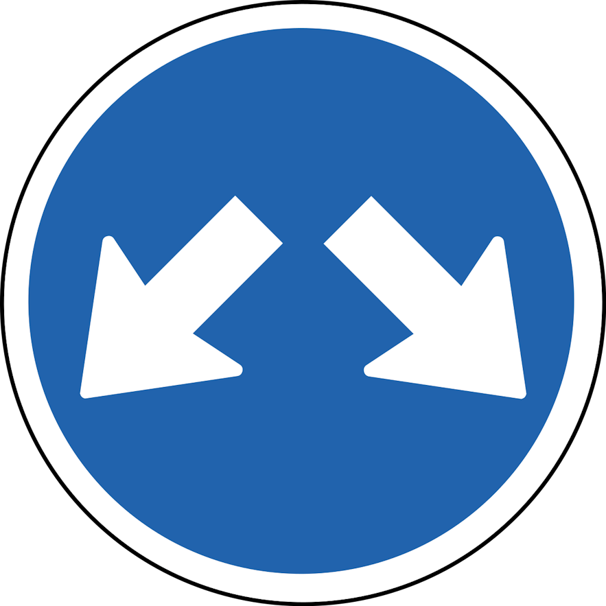 A blue circular sign with two small white arrows pointing to each side indicates you can pass on either side.