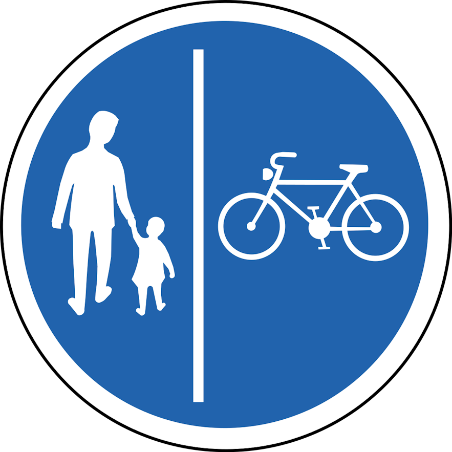A blue circular mandatory road sign in Iceland showing separate lanes for bicycles and pedestrians.